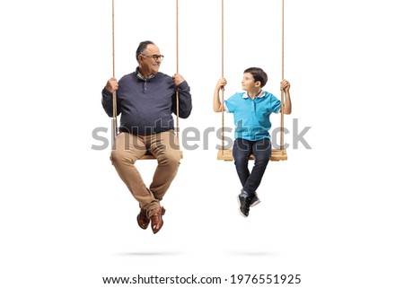 Grandfather swinging with his grandson isolated on white background