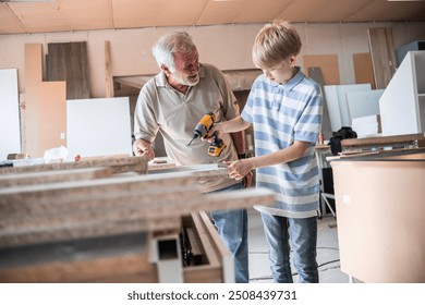 A grandfather teaches his grandson how to fix furniture in his carpenter workshop.	
 - Powered by Shutterstock