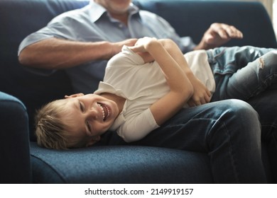 grandfather tickles his grandson at home