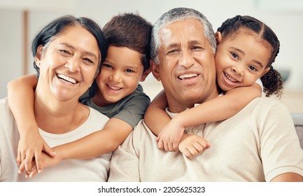 Grandkids Hug Grandparents For Love, Care And Relax In Family Home Together. Portrait Of Happy Children, Smile Senior Grandma And Laughing Elderly Grandpa Bond And Funny Play Together In Quality Time