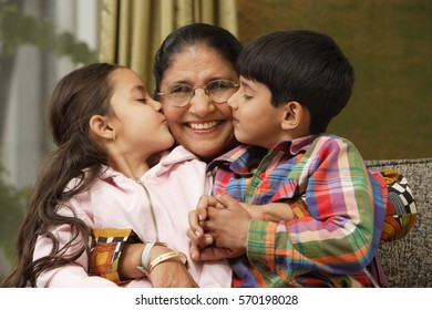 Grandkids Kiss Grandmother Cheeks