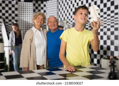 Grandkids Solving Conondrums In Escape Room And Their Grandparents Watching Them.