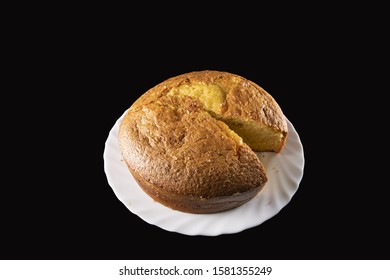 Grandma Cake Sliced, In A Wavy White Plate, On A Black Background