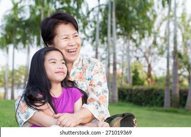 Grandma And Grandchild Hugging In The Park