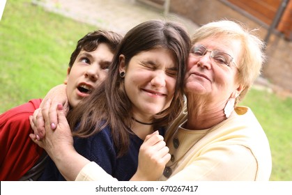 Grandma With Grandchildren Close Up Cuddle Photo On Summer Background