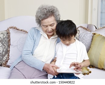 grandma and grandson looking at tablet computer together.
