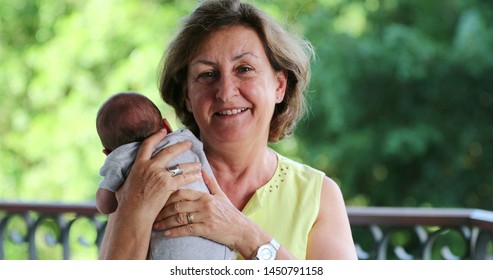 Grandma Holding Newborn Baby Grandson