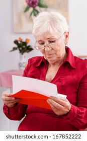 A Grandma Reading A Red Birthday Card