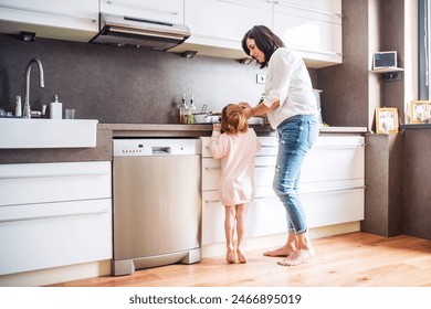 Grandma takes care of the grandchildren while parents are at work, spending time in kitchen, cooking together and having fun. - Powered by Shutterstock