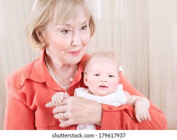 Grandmother With Baby On Hands At Home, Elegant Young Granny Having Fun With Grandchild, Happy Family Generation, New Life Concept