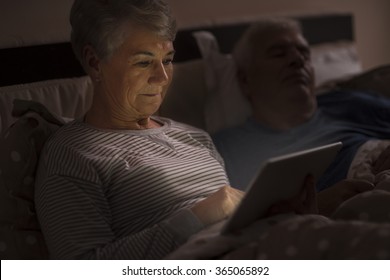 Grandmother browsing the Internet late at the night - Powered by Shutterstock