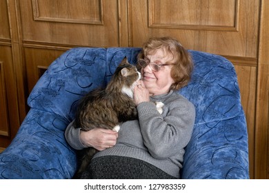 The grandmother with a cat in house conditions