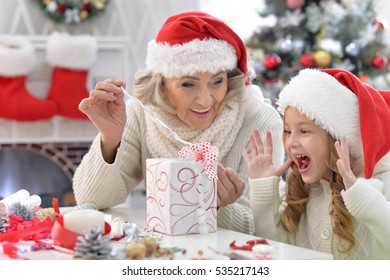 Grandmother And Child With Gift