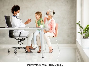 Grandmother With Cute Grandaughter Black Female Doctor In The Office