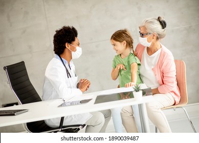 Grandmother With Cute Grandaughter Black Female Doctor In The Office