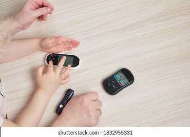 Grandmother Is Doing Glucose Level Finger Blood Test To Child