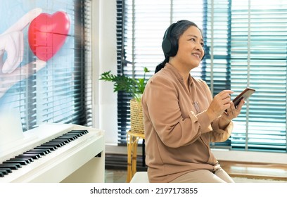 Grandmother Elderly Senior Woman Listen To The Music Song On Mobile Digital Internet Phone For Music Health Therapy. Sound Help Relax And Treatment Instrument Melody On Patient To Entertain Wellbeing