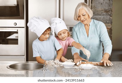 Grandmother of family baking christmas cookies with grandchildren together in her kitchen - Powered by Shutterstock