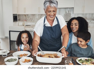 Grandmother, family home and kids at table for food, lunch or celebration with love, care and happiness. Black people, senior woman and children with dinner, party and happy for bonding in kitchen - Powered by Shutterstock