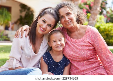 Grandmother In Garden With Daughter And Granddaughter