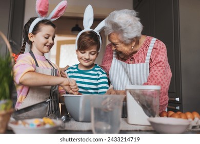 Grandmother with grandchildren preparing traditional easter meals, baking cakes and sweets. Passing down family recipes, custom and stories. - Powered by Shutterstock