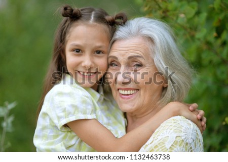 Similar – Grandma cuddles up with her grandson