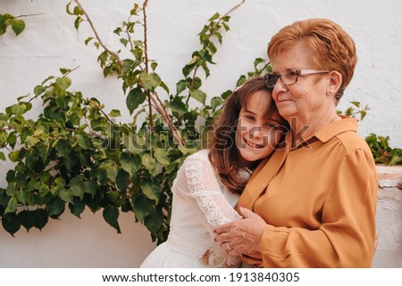 Similar – Woman taking selfie with older mother in wheelchair