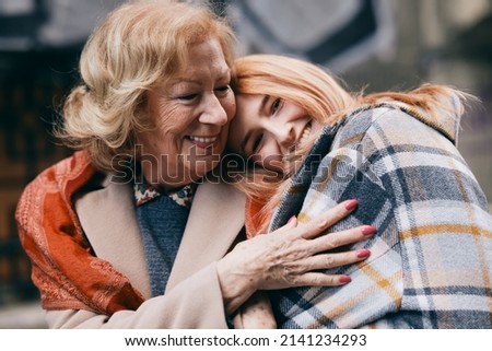 Similar – Woman taking selfie with older mother in wheelchair