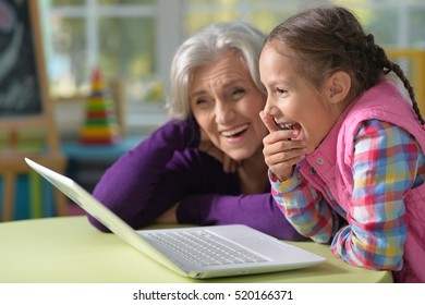 Grandmother and granddaughter with laptop - Powered by Shutterstock