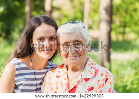 Grandmother and granddaughter. Grandmother and granddaughter are walking in the park