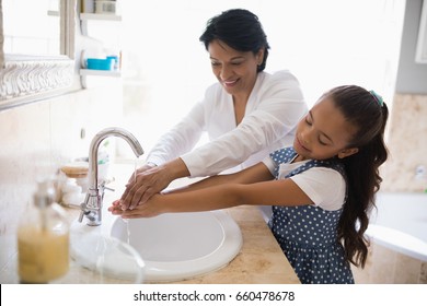 Grandmother and granddaughter washing hands at bathroom sink, Coronavirus hand washing for clean hands hygiene Covid19 spread prevention