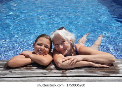 Grandmother with grandkid in resort swimming-pool - Powered by Shutterstock