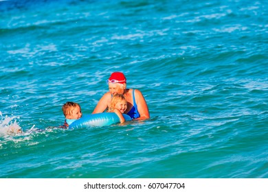 Grandmother With Grandkids Swimming Together