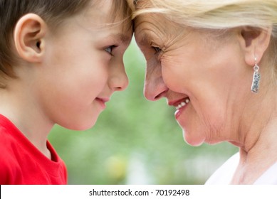 Grandmother with grandson on nature face to face