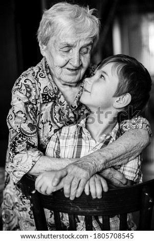 Similar – Grandma cuddles up with her grandson