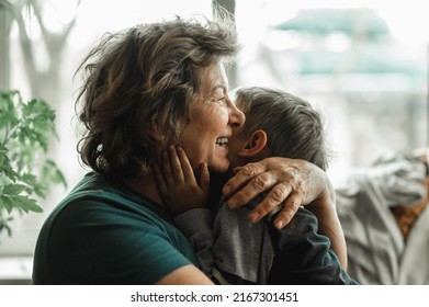 Grandmother and grandson spend time together, horizontal shot, the grandmother is no longer alone, smiling happily and hugging her little grandson