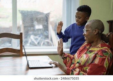 Grandmother with grandson using laptop at home - Powered by Shutterstock