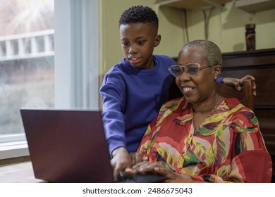 Grandmother with grandson using laptop at home - Powered by Shutterstock