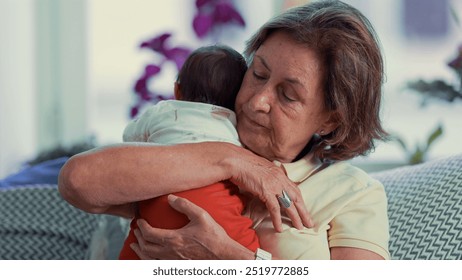 Grandmother holding newborn grandchild, highlighting a calm and affectionate intergenerational family bonding moment at home - Powered by Shutterstock