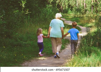 Grandmother With Kids Walk In Nature