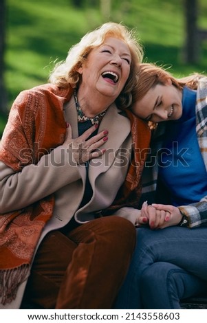 Similar – Young woman talking to elderly woman in wheelchair