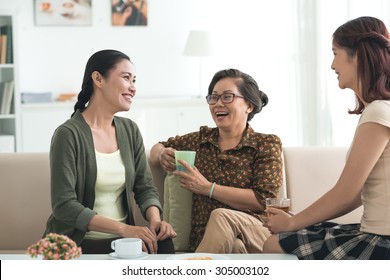 Grandmother, Mother And Daughter Drinking Tea And Having Good Time Together