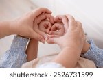 Grandmother, mother and daughter hands with heart shape, family unity, connection female generations, heartwarming image three generations women, feminine lineage