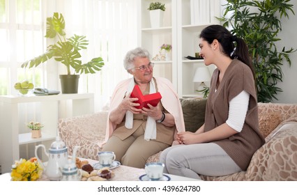 Grandmother Opening The Gift From Granddaughter