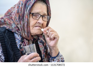 Grandmother, pill, health and the concept of a healthy lifestyle - an old woman takes pills - Shutterstock ID 1131708572