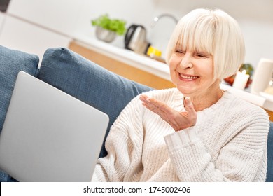 Grandmother Portrait Has Skype Conference Online Call Laptop Device Family Distance. Enjoy Time Have Fun Stay At Home. Old Woman Send Air Kiss Smile Feel Happy. Healthy Lady With White Hair Sit On