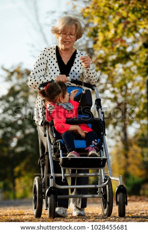 Similar – Granddaughter running to grandmother in wheelchair