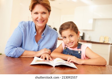 Grandmother Reading With Granddaughter At Home - Powered by Shutterstock