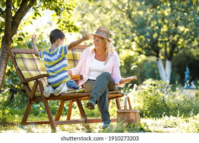 Grandmother sitting in garden and play with her grandson.	
 - Powered by Shutterstock