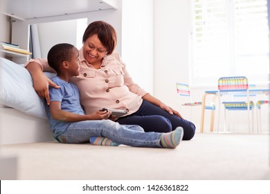 Grandmother Sitting With Grandson In Childs Bedroom Using Digital Tablet Together - Shutterstock ID 1426361822